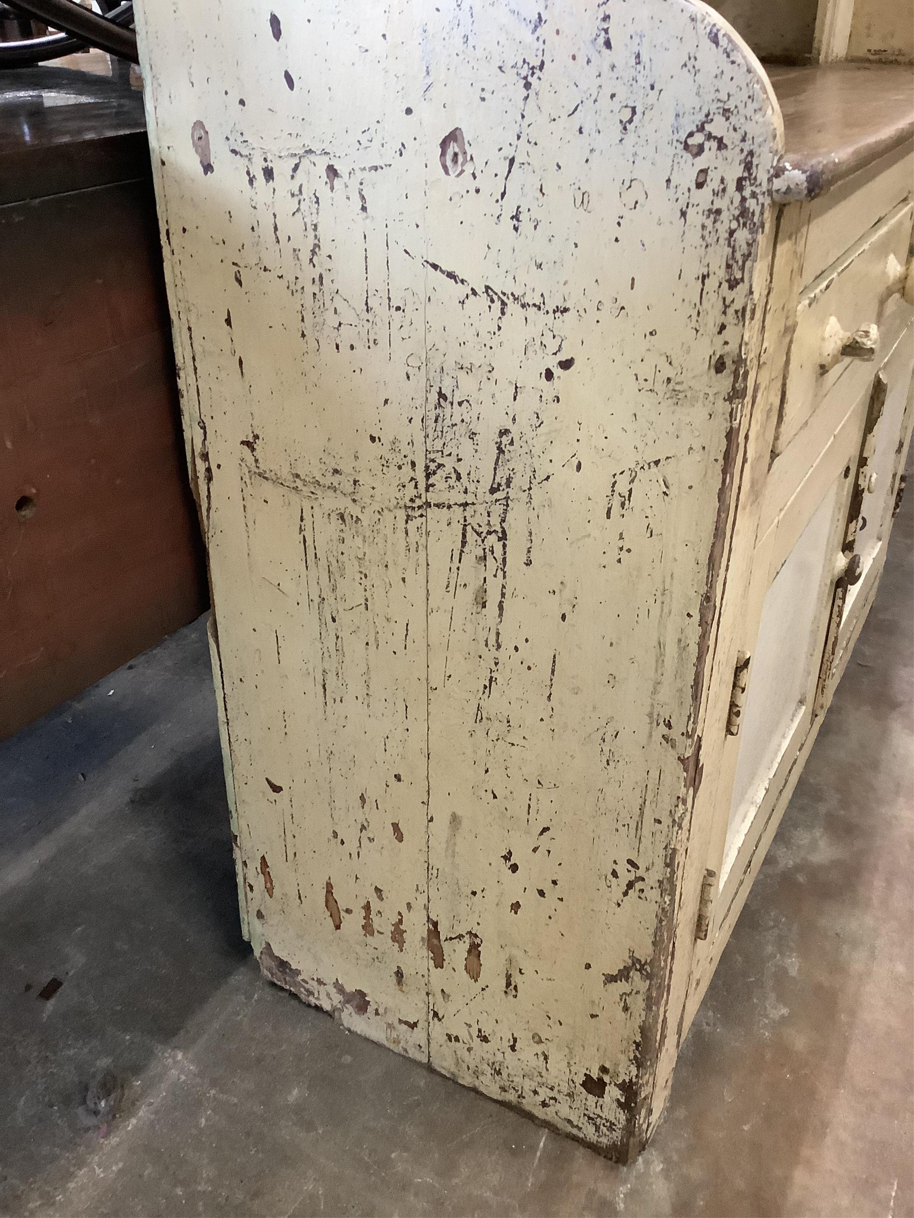 An early 19th century Irish painted pine dresser with boarded rack, width 126cm, depth 49cm, height 210cm. Condition - fair